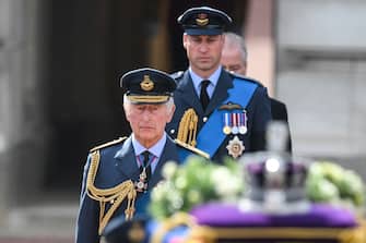 King Charles III and the Prince of Wales follow the coffin of Queen Elizabeth II, draped in the Royal Standard with the Imperial State Crown placed on top, as it is carried on a horse-drawn gun carriage of the King's Troop Royal Horse Artillery, during the ceremonial procession from Buckingham Palace to Westminster Hall, London, where it will lie in state ahead of her funeral on Monday. Picture date: Wednesday September 14, 2022.