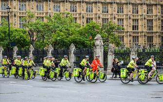 epa10183070 Police officers ride bicycles ahead procession to carry the body of Britain's late Queen Elizabeth II from Buckingham Palace to Westminster Hall, in London, Britain, 14 September 2022. The late queen will lie in state for four days inside Westminster Hall until the morning of her funeral, to be held on 19 September.  EPA / GUY BELL