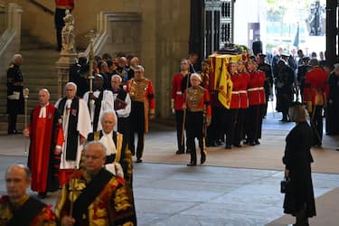 LONDON, ENGLAND - SEPTEMBER 14: The coffin of Queen Elizabeth II is carried into Westminster Hall for the Lying-in State on September 14, 2022 in London, England. Queen Elizabeth II's coffin is taken in procession on a Gun Carriage of The King's Troop Royal Horse Artillery from Buckingham Palace to Westminster Hall where she will lay in state until the early morning of her funeral. Queen Elizabeth II died at Balmoral Castle in Scotland on September 8, 2022, and is succeeded by her eldest son, King Charles III.  (Photo by David Ramos/Getty Images)