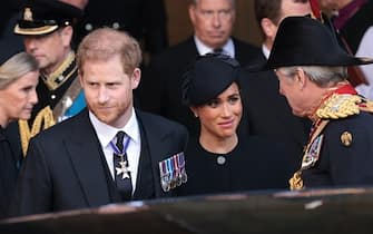 LONDON, ENGLAND - SEPTEMBER 14: Prince Harry, Duke of Sussex and Meghan, Duchess of Sussex at Westminster Hall on September 14, 2022, in London, England. Queen Elizabeth II's coffin is taken in procession on a Gun Carriage of The King's Troop Royal Horse Artillery from Buckingham Palace to Westminster Hall where she will lay in state until the early morning of her funeral. Queen Elizabeth II died at Balmoral Castle in Scotland on September 8, 2022, and is succeeded by her eldest son, King Charles III III. (Photo by Marko Djurica - Pool/Getty Images)