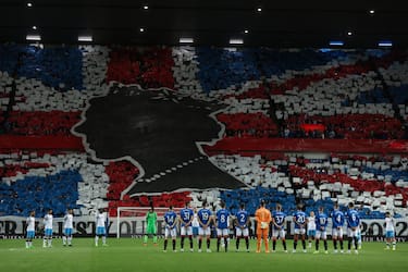GLASGOW, SCOTLAND - SEPTEMBER 14:  Rangers fans display a mural of the Union Jack flag to pay tribute to Her Majesty Queen Elizabeth II, during a minutes silence the UEFA Champions League group A match between Rangers FC and SSC Napoli at Ibrox Stadium on September 14, 2022 in Glasgow, United Kingdom. (Photo by Matthew Ashton - AMA/Getty Images)