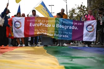 LGBT Activists hold rainbow banner during a pride march, in Belgrade, on September 17, 2022. - The situation was tense on September 17, 2022, in Belgrade where representatives of the LGBTQ community vowed to march despite a ban on a Europride march by the authorities, raising fears of potential unrest. (Photo by ANDREJ ISAKOVIC / AFP) (Photo by ANDREJ ISAKOVIC/AFP via Getty Images)