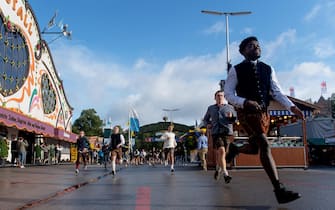 epa10189291 Visitors enter the grounds during the opening of the 187th edition of the traditional Oktoberfest beer and amusement festival in the Germany's Bavarian state capital of Munich, Germany, 17 September 2022. The Oktoberfest 2022 runs from 17 September to 03 October and several millions of visitors are expected from all over the world. Due to the coronavirus pandemic, the Oktoberfest was cancelled in 2020 and 2021.  EPA/CHRISTIAN BRUNA