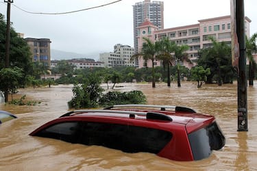 PUTIAN, CHINA - SEPTEMBER 01:  (CHINA OUT) A vehicle is trapped in a flooded street on September 1, 2011 in Putian, Fujian Province of China. Nanmadol, the 11th and strongest typhoon to hit China this year, struck the coast of east China's Fujian Province on Wednesday affecting more than 560,000 residents in the province and two reported casualties. The cost of the damage is estimated to be more than 44 million RMB (6.9 million USD), according to local authorities.  (Photo by Getty Images)