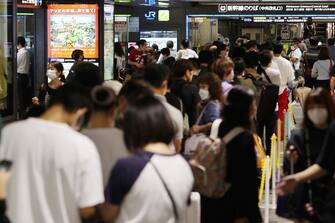 Passengers gather as train service is suspended due to Typhoon Nanmadol approaching Kyushu region, at Hakata station of Fukuoka on September 18, 2022. - Japan OUT (Photo by JIJI PRESS / AFP) / Japan OUT (Photo by STR / JIJI PRESS / AFP via Getty Images)