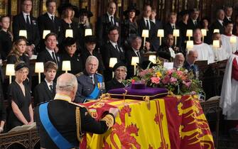 King Charles III places the the Queen's Company Camp Colour of the Grenadier Guards on the coffin at the Committal Service for Queen Elizabeth II, held at St George's Chapel in Windsor Castle, Berkshire., Credit:Jonathan Brady / Avalon