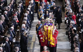 King Charles III, the Queen Consort, the Princess Royal, Vice Admiral Sir Tim Laurence, the Duke of York, the Earl of Wessex, the Countess of Wessex, the Prince of Wales, the Princess of Wales, Prince George, Princess Charlotte, the Duke of Sussex, the Duchess of Sussex, Peter Phillips and the Earl of Snowdon follow behind the coffin of Queen Elizabeth II, draped in the Royal Standard with the Imperial State Crown and the Sovereign's orb and sceptre, as it is carried out of Westminster Abbey after her State Funeral. Picture date: Monday September 19, 2022.
