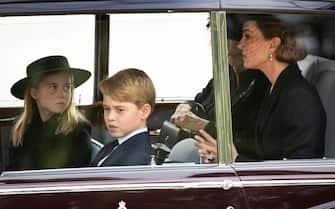 LONDON, ENGLAND - SEPTEMBER 19: Camilla, Queen Consort, Catherine, Princess of Wales, Prince George of Wales, Princess Charlotte of Wales follow the cortÃ¨ge of the late Queen Elizabeth II as it is pulled past the Houses of Parliament after her funeral at Westminster Abbey on September 19, 2022 in London, England. Elizabeth Alexandra Mary Windsor was born in Bruton Street, Mayfair, London on 21 April 1926. She married Prince Philip in 1947 and ascended the throne of the United Kingdom and Commonwealth on 6 February 1952 after the death of her Father, King George VI. Queen Elizabeth II died at Balmoral Castle in Scotland on September 8, 2022, and is succeeded by her eldest son, King Charles III. (Photo by Joshua Bratt- WPA Pool/Getty Images)
