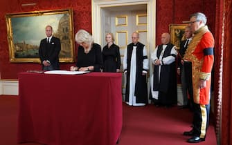 LONDON, ENGLAND - SEPTEMBER 10: The Queen signs the Proclamation of Accession of King Charles III, watched by (left-right back) the Prince of Wales, Prime Minister Liz Truss , Archbishop of Canterbury, Justin Welby, Archbishop of York, Stephen Cottrell, Lord Chancellor of the Privy Council Brandon Lewis and Earl Marshal, Edward Fitzalan-Howard, the Duke of Norfolk during the Accession Council ceremony at St James's Palace, London, where King Charles III is formally proclaimed monarch on September 10, 2022 in London, United Kingdom. His Majesty The King is proclaimed at the Accession Council in the State Apartments of St James's Palace, London. The Accession Council, attended by Privy Councillors, is divided into two parts. In part I, the Privy Council, without The King present, proclaims the Sovereign and part II where The King holds the first meeting of His Majesty's Privy Council. The Accession Council is followed by the first public reading of the Principal Proclamation read from the balcony overlooking Friary Court at St James's Palace. The Proclamation is read by the Garter King of Arms, accompanied by the Earl Marshal, other Officers of Arms and the Serjeants-at-Arms. (Photo by Kirsty O'Connor - WPA Pool/Getty Images)