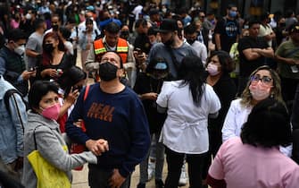 People remain in the street after an earthquake in Mexico City on September 19, 2022. - A 6.8-magnitude earthquake struck western Mexico on Monday, shaking buildings in Mexico City on the anniversary of two major tremors in 1985 and 2017, seismologists said.  (Photo by Alfredo ESTRELLA / AFP) (Photo by ALFREDO ESTRELLA / AFP via Getty Images)