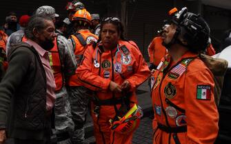 MEXICO CITY, MEXICO - SEPTEMBER 19: Topos Azteca Rescuers remain outside a building after a 7.7 magnitude quake that struck the west coast in Guerrero State, was felt in Mexico City right after a drill to commemorate two prior earthquakes that took place on this same date in 1985 and 2017 on September 19, 2022 in Mexico City, Mexico. (Photo by Cristopher Rogel Blanquet/Getty Images)