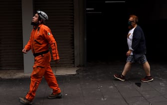 MEXICO CITY, MEXICO - SEPTEMBER 19: A Topo Azteca Rescuer walks outside a building after a 7.7 magnitude quake that struck the west coast in Guerrero State, was felt in Mexico City right after a drill to commemorate two prior earthquakes that took place on this same date in 1985 and 2017 on September 19, 2022 in Mexico City, Mexico. (Photo by Cristopher Rogel Blanquet/Getty Images)