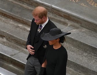 The Duke and Duchess of Sussex follow the bearer party with the coffin of Queen Elizabeth II as it is taken from Westminster Abbey, London at the end of service during the State Funeral of the late monarch Picture date: Monday September 19, 2022.
