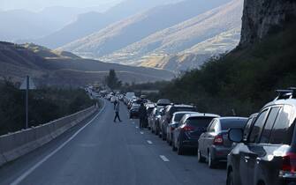 VLADIKAVKAZ, REPUBLIC OF NORTH OSSETIA-ALANIA, RUSSIA - SEPTEMBER 27, 2022: Vehicles queue at an exit from the city. According to the Russian Interior Ministry, over the period between September 17 and 26, about 78,000 Russian nationals entered Georgia, over 62,000 returned. The North Ossetian authorities are planning to restrict access of non-residential motor vehicles to the republic. Mobile task groups of draft and law enforcement officials are positioned at entrances to the republic and the Verkhny Lars checkpoint on the Russian-Georgian border to hand out draft notices. Russian President Putin announced partial military mobilization in Russia on September 21. Valery Sharifulin/TASS/Sipa USA