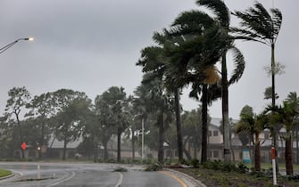 SARASOTA, FLORIDA - SEPTEMBER 28: Palm trees blow in the wind from Hurricane Ian on September 28, 2022 in Sarasota, Florida.  Ian is hitting the area with winds and rain as a possible category 4 hurricane.  (Photo by Joe Raedle / Getty Images)