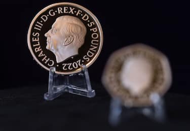 A five pound commemorative crown piece coin featuring the head of King Charles III displayed next to a 50 pence coin by the Royal Mint in London, UK, on Thursday, Sept. 29, 2022. The King's portrait which, sculptor Martin Jennings designed to face the opposite direction to his mothers, was approved by the monarch himself and seen by chancellor Kwasi Kwarteng in a process that kicked off after the Queen passed away. Photographer: Chris Ratcliffe/Bloomberg via Getty Images