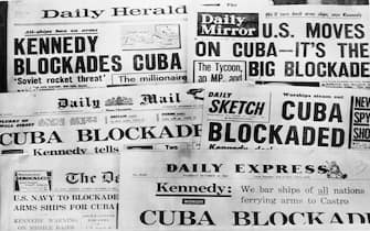 Banner headlines of Britain's daily newspapers Oct. 23 announcing President Kennedy's blockade of Cuba. U.S. planes and ships, armed with orders to shoot if necessary, began taking up positions in the Caribbean Oct. 22 to cut off shipments of Communist offensive weapons to Cuba. The action aw ordered by President Kennedy who soberly told the nation in a national television address that Soviet missiles and other weapons had turned Cuba into an armed camp capable of hurling destruction into the heart of America.