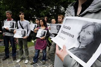 People demonstrate during a rally in memory of murdered human rights activist Natalia Estemirova, in Brussels on July 17, 2009.  Estemirova, 50, was abducted outside her home in the troubled Russian province of Chechnya on July 15, 2009. Her body was found with gunshot wounds to the head and chest later the same day in the neighboring region of Ingushetia. AFP PHOTO / Dominique FAGET (Photo credit should read DOMINIQUE FAGET/AFP via Getty Images)