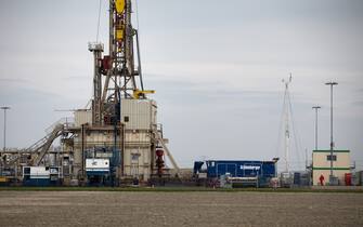 A drilling rig stands on an onshore gas extraction site operated by Nederlandse Aardolie Maatschappij BV (NAM) in the Loppersum gas field cluster in 't Zandt, Groningen, Netherlands, on Tuesday, April 14, 2015. A Dutch court ordered that production from the Loppersum area of the Groningen natural gas field, Europe's biggest, be limited as earthquakes linked to production damaged homes in the nation's most northerly province. Photographer: Jasper Juinen/Bloomberg via Getty Images