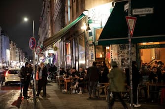 BERLIN, GERMANY - OCTOBER 16: People gather at bar in Kreuzberg district on October 16, 2020 in Berlin, Germany. About 11 bars and restaurants in city led a successful challenge to the recent 11pm curfew imposed by Berlin health authorities as a measure to slow the spread of the virus. The court rejected the argument, saying it saw no reason why the curfew would help against the virus, but it upheld a ban on the sale of alcohol after 11pm. (Photo by Maja Hitij/Getty Images)