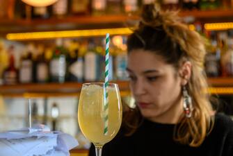 LISBON, PORTUGAL - MARCH 28: A bartender is seen behind a drink at CafÃ© Janis, in Cais do SodrÃ©, on March 28, 2019 in Lisbon, Portugal. Although active all year round, Portuguese tourist industry is gearing up for an excellent summer season, for the country is rated as very safe by travelers. (Photo by Horacio Villalobos - Corbis/Getty Images)