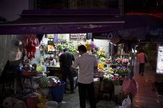 A customer waits at a flower market stall in Bangkok, Thailand, on Wednesday, Jan. 31, 2018. Thai consumer confidence climbs to highest in about three years, according to the University of Thai Chamber of Commerce. Photographer: Brent Lewin/Bloomberg via Getty Images