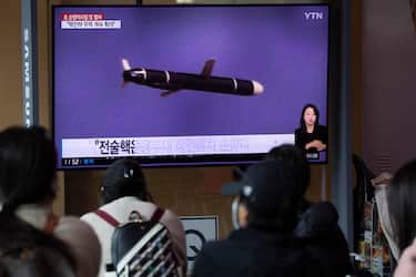 epa10240029 People watch the news at a station in Seoul, South Korea, 13 October 2022. According to reports from North Korean state run media, North Korea launched two long-range cruise missiles into the East Sea.  EPA/JEON HEON-KYUN