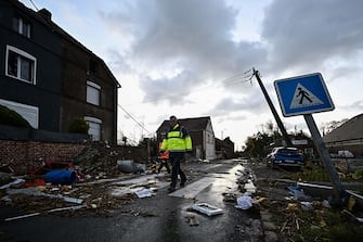 Municipal workers walk past damages in Bihucourt, northern France, on October 24, 2022 after a tornado hit the region. (Photo by Sameer Al-Doumy / AFP) (Photo by SAMEER AL-DOUMY/AFP via Getty Images)
