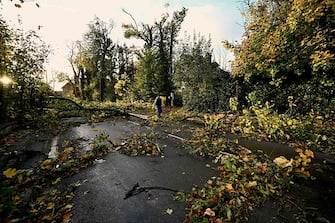 A local resident walks past fallen branches Bihucourt, northern France, on October 24, 2022 after a tornado hit the region. (Photo by Sameer Al-Doumy / AFP) (Photo by SAMEER AL-DOUMY/AFP via Getty Images)