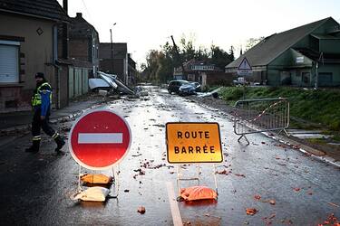 A French gendarme walks a closed road in Bihucourt, northern France, on October 24, 2022 after a tornado hit the region. (Photo by Sameer Al-Doumy / AFP) (Photo by SAMEER AL-DOUMY/AFP via Getty Images)