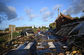 TOPSHOT - Local residents walk past damages in Bihucourt, northern France, on October 24, 2022 after a tornado hit the region. (Photo by Sameer Al-Doumy / AFP) (Photo by SAMEER AL-DOUMY/AFP via Getty Images)