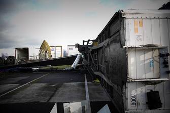 This photograph taken in Beuzeville, northern France on October 24, 2022, shows a damaged truck in the car park of a transportation company, after a tornado hit the region. (Photo by Lou BENOIST / AFP) (Photo by LOU BENOIST/AFP via Getty Images)