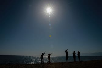 ANTALYA, TURKIYE - OCTOBER 25: People observe the partial solar eclipse in Antalya, Turkiye on October 25, 2022. (Photo by Orhan Cicek/Anadolu Agency via Getty Images)