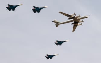 MOSCOW REGION, RUSSIA - APRIL 18, 2022: Sukhoi Su-35 fighter aircraft and a Tupolev Tu-95 strategic bomber (R) take part in a rehearsal of a Victory Day military parade in Red Square marking the 77th anniversary of the victory over Nazi Germany in World War II, at the Alabino training ground. Sergei Fadeichev/TASS/Sipa USA