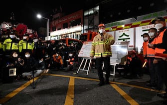 An official speaks during a briefing about the Halloween crush, which left at least 120 people dead, in the district of Itaewon in Seoul on October 30, 2022. - At least 120 people were killed on October 29 and some 100 were injured in a stampede in central Seoul when thousands crowded into narrow streets to celebrate Halloween, officials said. (Photo by Anthony WALLACE / AFP) (Photo by ANTHONY WALLACE/AFP via Getty Images)