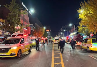 epa10273550 Police officers guard a road in Seoul's Itaewon district after a stampede during Halloween parties in Seoul, South Korea, 29 October 2022. At least 50 people suffer from cardiac arrest during a stampede in the Itaewon area of Seoul as a huge crowd came to celebrate Halloween, according to Yonhap news agency.  EPA/JEON HEON-KYUN