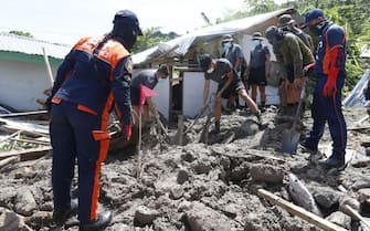 MAGUINDANAO, PHILIPPINES - OCTOBER 30: Rescuers exhume the bodies after landslide and flash flood hit town of Datu Odin Sinsuat in Philippines on October 30, 2022. The death toll from floods and landslides triggered by Tropical Storm Nalgae (Philippine name Paeng) has reached nearly 50 and many are still missing. (Photo by Jeoffrey Maitem/Anadolu Agency via Getty Images)