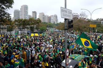 epa10281872 Supporters of Brazil's outgoing President Jair Bolsonaro protest against the election results, outside the Brazilian Army barracks in Sao Paulo, Brazil, 2 November 2022. Thousands of people have gathered in front of the gates of barracks in Sao Paulo, Brasilia and Rio de Janeiro to demand a 'military intervention' against the electoral victory of progressive leader Luiz Inacio Lula da Silva. The rallies were organized through social networks by far-right groups that support Bolsonaro and do not recognize Lula's democratic election.  EPA/Fernando Bizerra