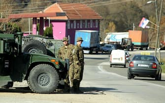 epa10279178 Members of the Latvian contingent of NATO-led international peacekeeping force in Kosovo (KFOR) observe the Jarinje border crossing between Kosovo and Serbia at Jarinje, Kosovo, 01 November 2022. The Government of Kosovo will begin implementing a plan to eliminate the usage of Serbian car license plates. All owners of vehicles with Serbian number plates are warned and requested to visit any of the Vehicle Registration Centers and register their vehicles with RKS license plates. In the Serbian community of Kosovo, the RKS license plates are seen as unacceptable as they suggest the recognition of independence of the Republic of Kosovo.  EPA/DJORDJE SAVIC
