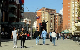 epa10279176 People walk in front of the statue of Serbian Duke Lazar who was killed at the Battle of Kosovo in June 1389, in the northern Serb-dominated part of ethnically divided town of Mitrovica, Kosovo, 01 November 2022. The Government of Kosovo will begin implementing a plan to eliminate the usage of Serbian car license plates. All owners of vehicles with Serbian number plates are warned and requested to visit any of the Vehicle Registration Centers and register their vehicles with RKS license plates. In the Serbian community of Kosovo, the RKS license plates are seen as unacceptable as they suggest the recognition of independence of the Republic of Kosovo.  EPA/DJORDJE SAVIC