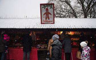 People visit a Christmas market at the Skansen open air museum during Advent Sunday on November 27, 2016 in Stockholm.   / AFP / JONATHAN NACKSTRAND        (Photo credit should read JONATHAN NACKSTRAND/AFP via Getty Images)
