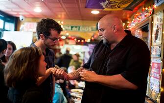 UNITED STATES - APRIL 3: U.S. Senate candidate and Braddock, Pa. Mayor John Fetterman shows off his tattoos as he speaks with supporters during his meet and greet campaign stop at the Interstate Drafthouse in Philadelphia on Sunday, April 3, 2016. Fetterman is running as a Democrat for Sen. Pat Toomey's seat.  (Photo By Bill Clark/CQ Roll Call)