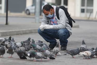 A men, feeding the pigeons in the streets of Alvalade neighborhood, Lisbon, 29th March, 2020.
Europe has become the epicenter of the COVID-19 outbreak, with one-third of globally reported cases now stemming from the region. (Photo by Valter Gouveia/NurPhoto via Getty Images)