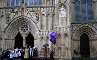Britain's King Charles III, watched by Britain's Camilla, Queen Consort, unveils a statue of his late mother, Queen Elizabeth II, during a visit to York Minster in York, northern England  on November 9, 2022 as part of his two-day tour of Yorkshire. - The statue of Queen Elizabeth II is one of a number of projects emerging from the York Minster Neighbourhood Plan and funded by the York Minster Fund (YMF), and was designed and carved by York Minster stonemason Richard Bossons. (Photo by Lindsey Parnaby / AFP) (Photo by LINDSEY PARNABY/AFP via Getty Images)
