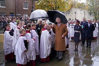 Britain's King Charles III, accompanied by Britain's Camilla, Queen Consort, looks up toward a statue of his late mother, Queen Elizabeth II, after he unveiled it during a visit to York Minster in York, northern England on November 9, 2022 as part of his two-day tour of Yorkshire. - The statue of Queen Elizabeth II is one of a number of projects emerging from the York Minster Neighbourhood Plan and funded by the York Minster Fund (YMF), and was designed and carved by York Minster stonemason Richard Bossons. (Photo by Danny Lawson / POOL / AFP) (Photo by DANNY LAWSON/POOL/AFP via Getty Images)