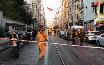 Investigators stand behind a military after a bomb blast on a pedestrian thoroughfare popular with tourists in central Istanbul, Turkey, Sunday, November 13, 2022. The explosion killed at least four people and left 38 wounded. (Photo by Arnaud Andrieu/Sipa Press).