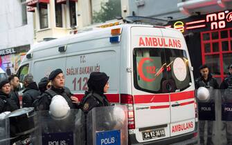 An ambulance drives through a police line after a bomb blast on a pedestrian thoroughfare popular with tourists in central Istanbul, Turkey, Sunday, November 13, 2022. The explosion killed at least four people and left 38 wounded. (Photo by Arnaud Andrieu/Sipa Press).