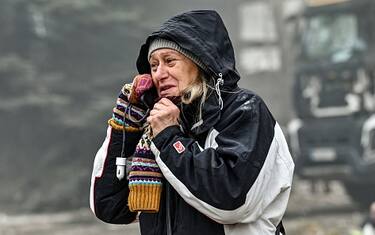ZAPORIZHZHIA, UKRAINE - NOVEMBER 6, 2022 - Elia, the mother of the man whose body was found under the rubble, talks on the phone during a response effort to a Russian missile attack which left a commercial enterprise destroyed, Zaporizhzhia, southeastern Ukraine. (Photo credit should read Dmytro Smolienko / Ukrinform/Future Publishing via Getty Images)