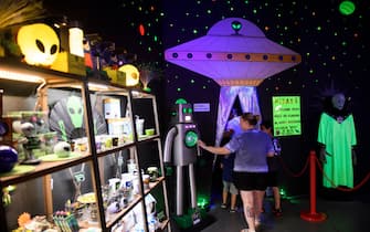 People enter the Roswell UFO Spacewalk attraction during the UFO Festival on July 2, 2021 in Roswell, New Mexico. - The festival returns during the July 4th holiday weekend following the Covid-19 pandemic. A highly awaited US intelligence report on dozens of mysterious unidentified flying object sightings said most could not be explained, but did not rule out that some could be alien spacecraft. The report made no mention of the possibility of -or rule out - that some of the objects sighted could represent extra-terrestrial life. The military and intelligence community have conducted research on them as a potential threat. (Photo by Patrick T. FALLON / AFP) (Photo by PATRICK T. FALLON/AFP via Getty Images)