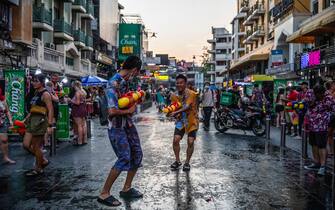 BANGKOK, THAILAND - APRIL 13: Thai tourists and locals celebrate Songkran by spraying each other with water guns and partying on Khaosan Road on April 13, 2022 in Bangkok, Thailand. Songkran, the traditional Thai New Year's Festival, is celebrated each April, Thailand's hottest month of the year. During Songkran, locals and tourists celebrate by partaking in water fights throughout the country. This year, despite the Thai government officially banning water fights due to the rise in Covid-19 cases, revelers joined party's on Khaosan Road and at a pro-democracy rally near Democracy Monument. (Photo by Lauren DeCicca/Getty Images)